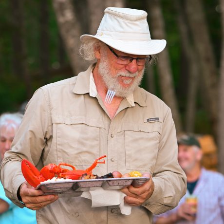 A man eating at Maine Lobster Festival at Sea Swell Campgrounds